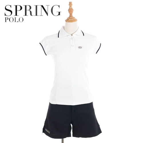 Women's white polo shirt with navy trim by Spring Polo, styled with navy shorts on a mannequin